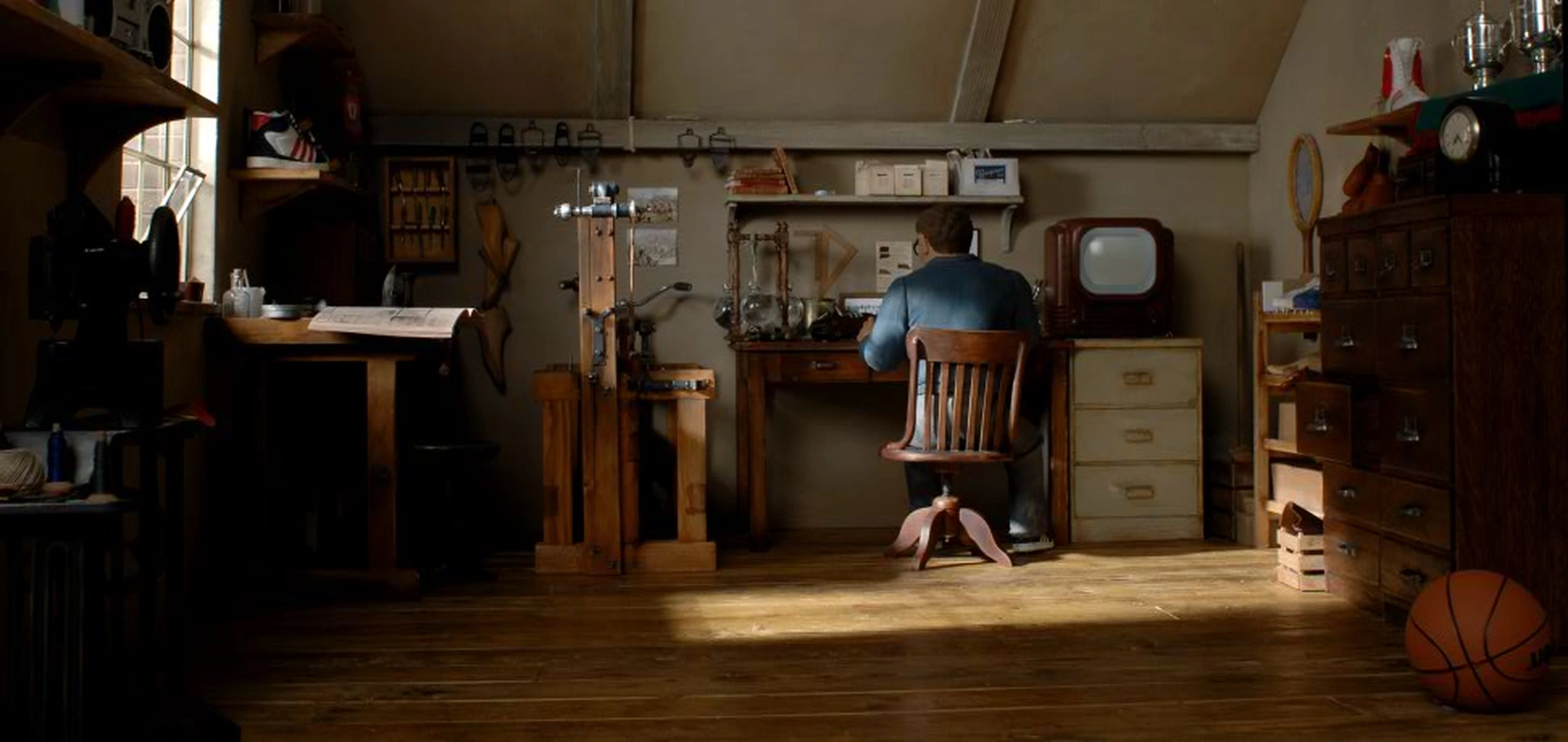 Adi working at his bench, surrounded by shoes, tools, a tennis racket and a basketball.